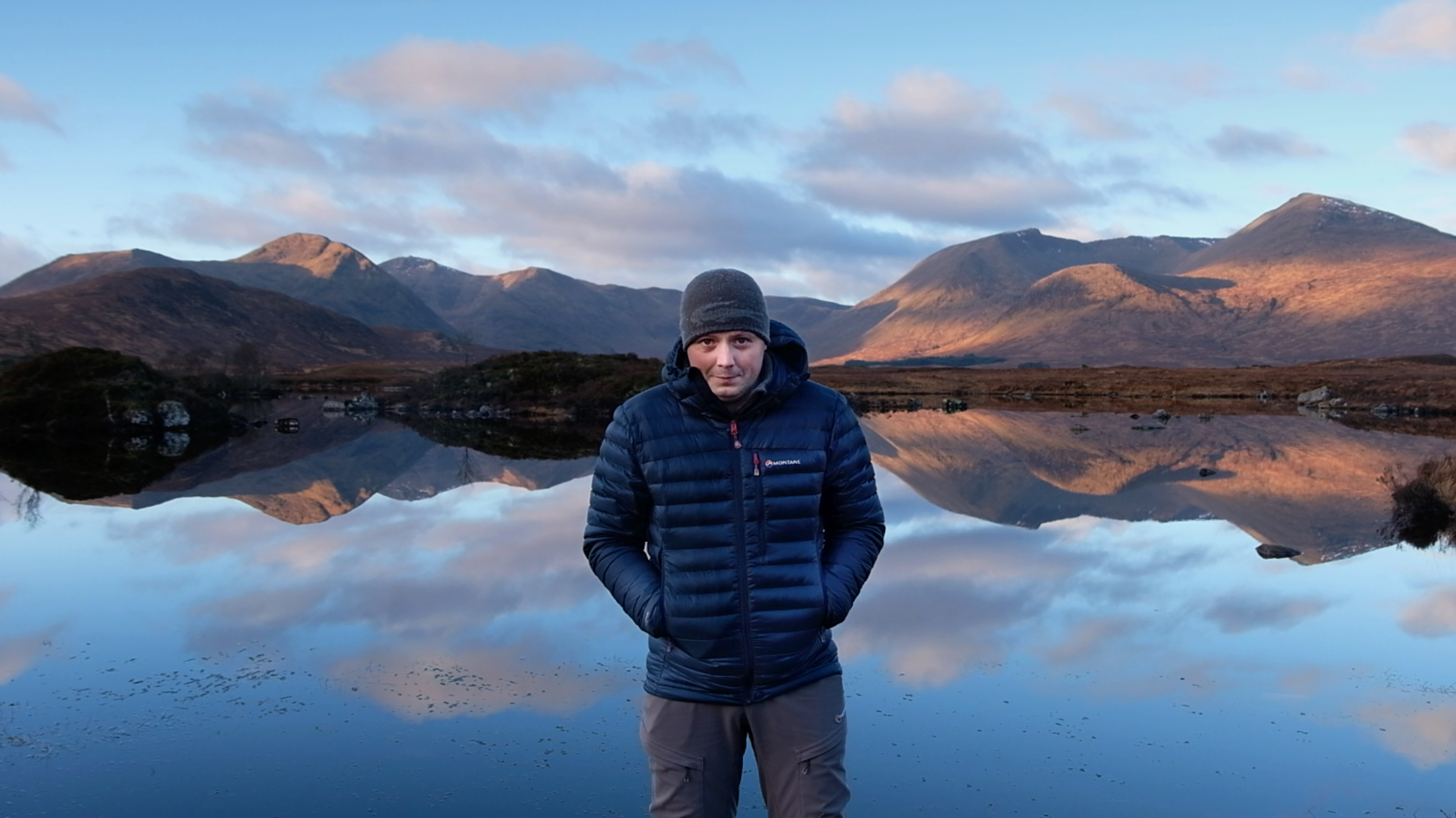 Landscape photographer Jamie Howden standing in front of Lochan n-ah achlaise, Glencoe